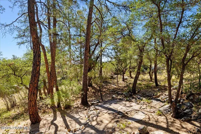 a view of a swimming pool with a yard and sitting area