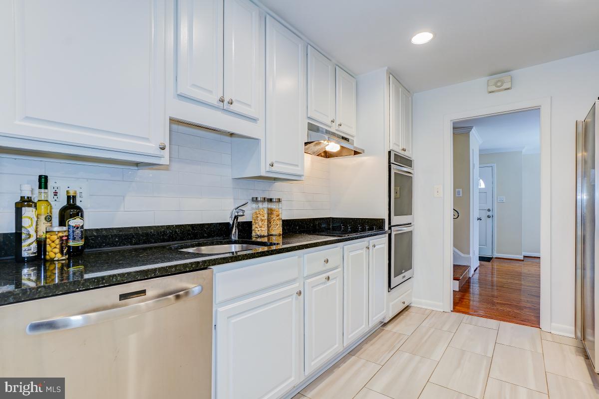 6503 Dryden Drive McLean, VA 22101 - Photo 10 of 34 a kitchen with granite countertop a sink a stove and cabinets