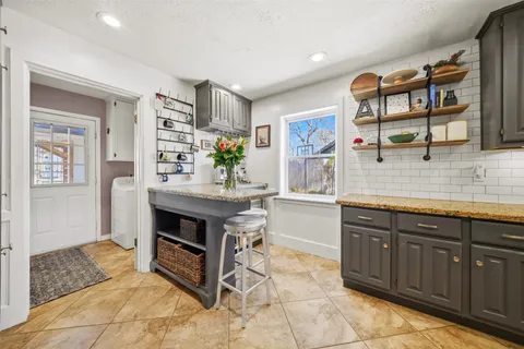 a kitchen with stainless steel appliances a stove and cabinets