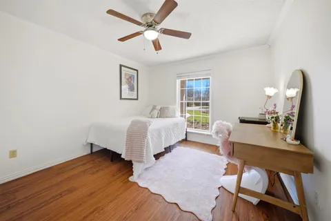 a bedroom with a bed window and a table