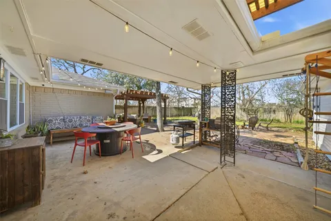 a living room with patio furniture and a large window