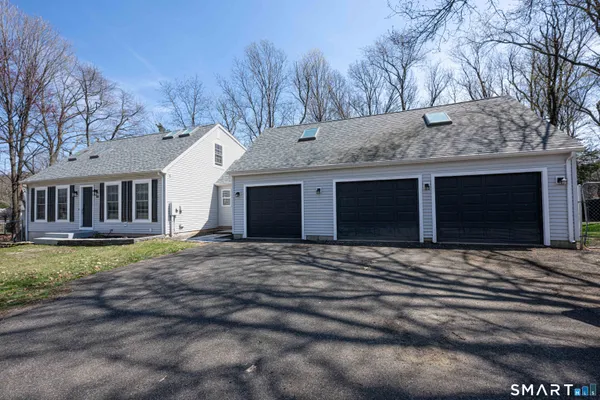 a view of a house with a yard and garage