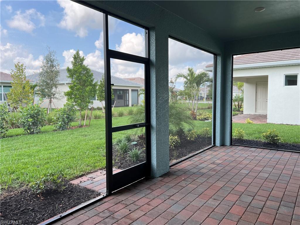 393 Deauville Loop Naples, FL 34114 - Photo 18 of 19 Unfurnished sunroom featuring healthy amount of natural light