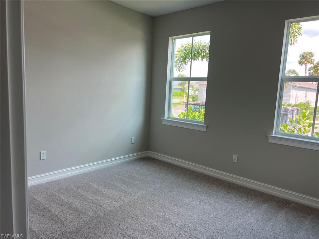 393 Deauville Loop Naples, FL 34114 - Photo 2 of 19 Empty room featuring carpet flooring and baseboards