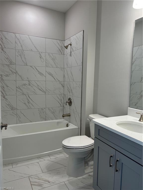 393 Deauville Loop Naples, FL 34114 - Photo 3 of 19 Bathroom with marble finish flooring, shower / washtub combination, toilet, and vanity