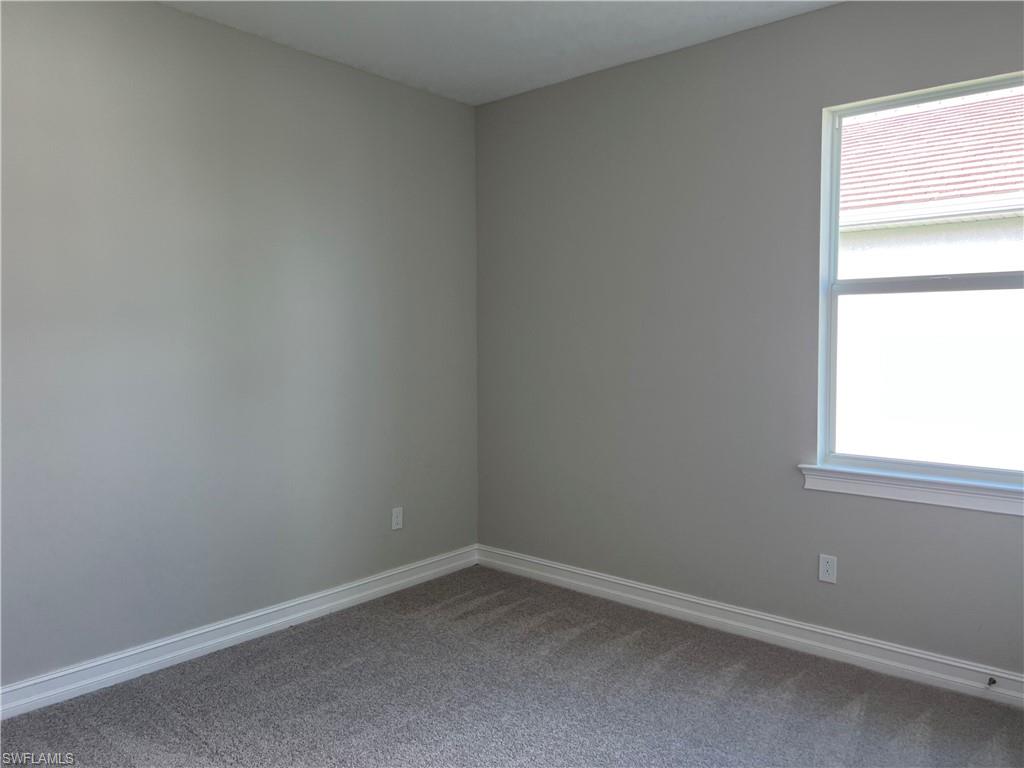 393 Deauville Loop Naples, FL 34114 - Photo 4 of 19 Carpeted empty room with baseboards