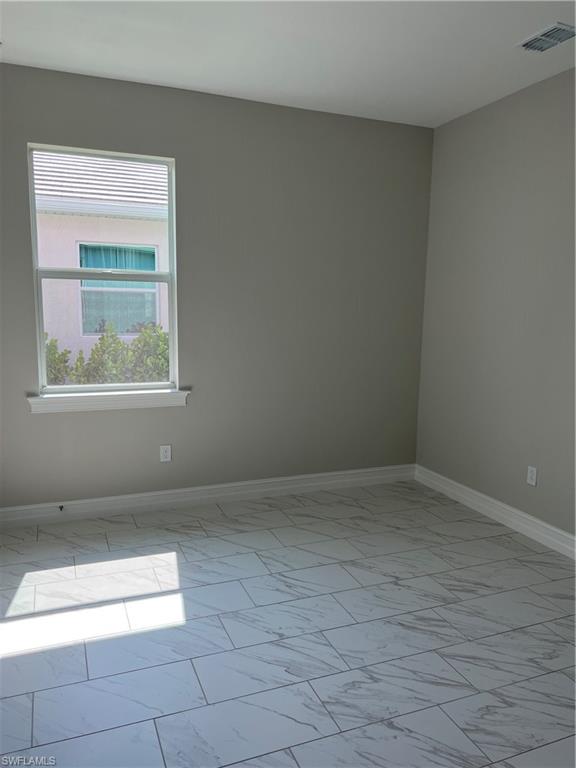 393 Deauville Loop Naples, FL 34114 - Photo 5 of 19 Unfurnished room with marble finish floors and baseboards
