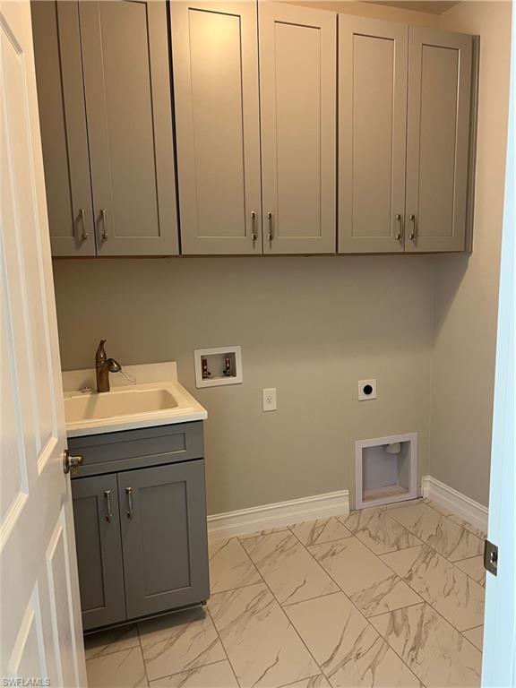 393 Deauville Loop Naples, FL 34114 - Photo 6 of 19 Laundry area with washer hookup, electric dryer hookup, cabinet space, light marble finish flooring, and baseboards