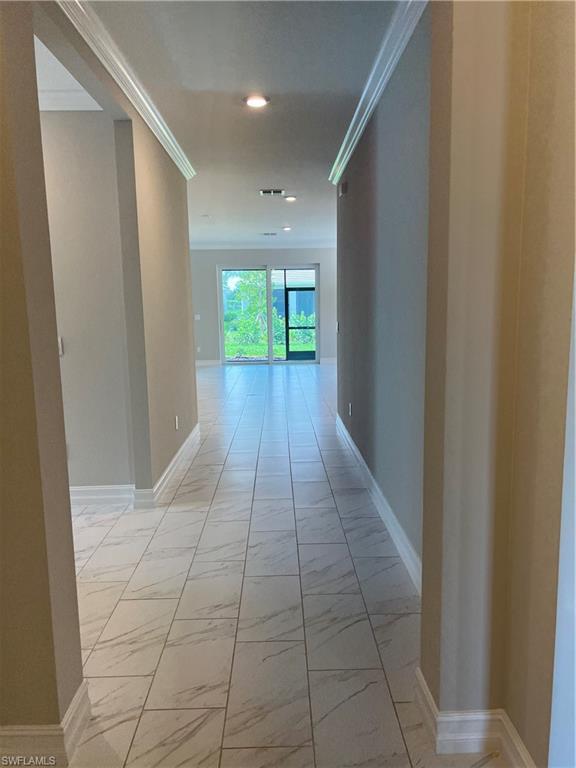 393 Deauville Loop Naples, FL 34114 - Photo 8 of 19 Hallway with light marble finish flooring, recessed lighting, baseboards, and crown molding