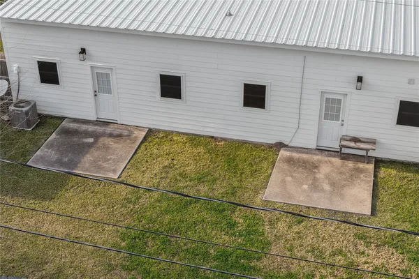 a backyard of a house with table and chairs