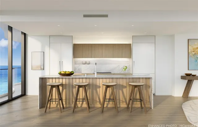 a kitchen with stainless steel appliances a table and chairs in it