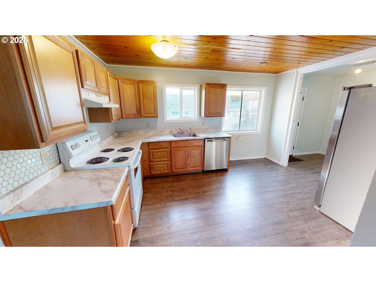 94273 Leith Road Gold Beach, OR 97444 - Photo 4 of 20 a open kitchen with stainless steel appliances granite countertop a sink stove and refrigerator