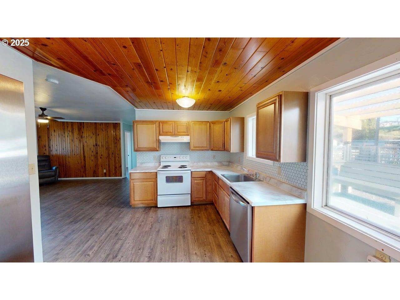 94273 Leith Road Gold Beach, OR 97444 - Photo 5 of 20 a open kitchen with granite countertop a sink cabinets and wooden floor