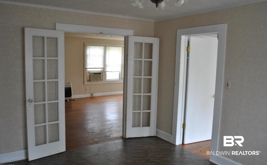 1059 Alabama Street Loxley, AL 36551 - Photo 5 of 12 Spare room with french doors, dark wood-type flooring, cooling unit, and crown molding