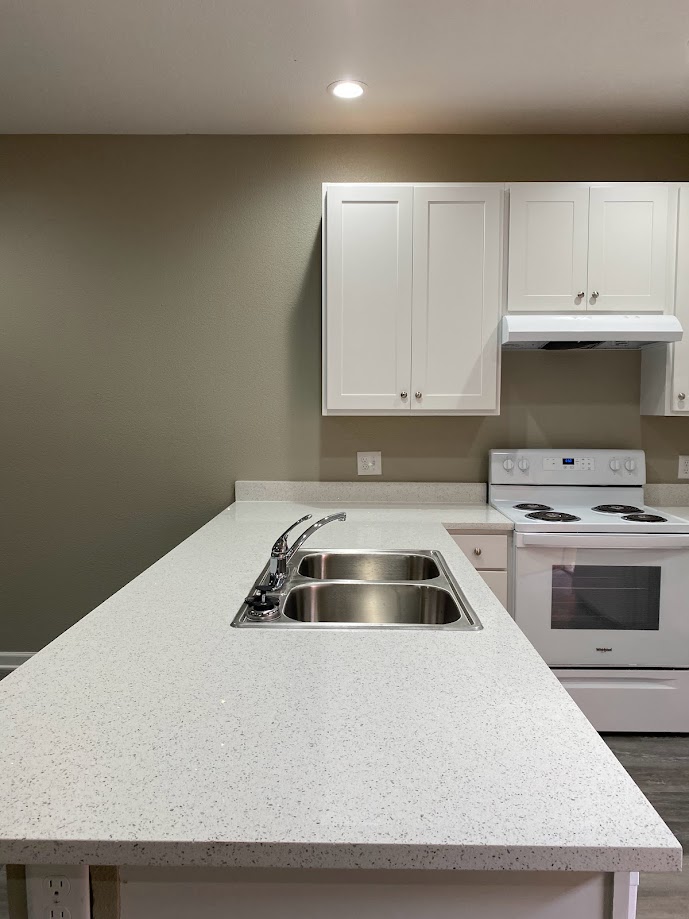 1305 West Villa Maria Road, Unit D103 Bryan, TX 77801 - Photo 3 of 12 a kitchen with a sink a stove and cabinets