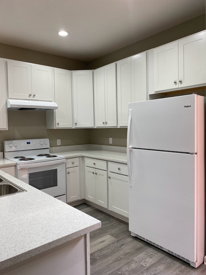 1305 West Villa Maria Road, Unit D103 Bryan, TX 77801 - Photo 4 of 12 a kitchen with cabinets stainless steel appliances and wooden floor