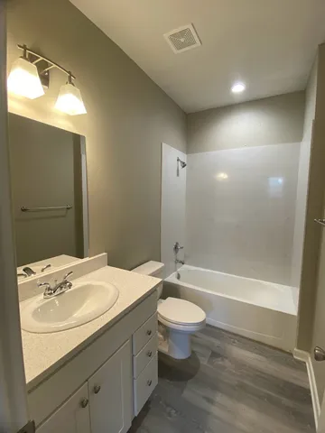 a bathroom with a sink a toilet and bathtub