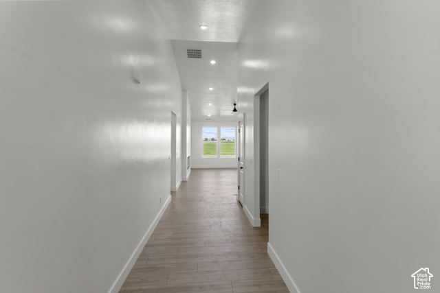 205 East 690th Street North Logan, UT 84321 - Photo 4 of 52 Recessed lighting illuminates wood-finish flooring in this hallway