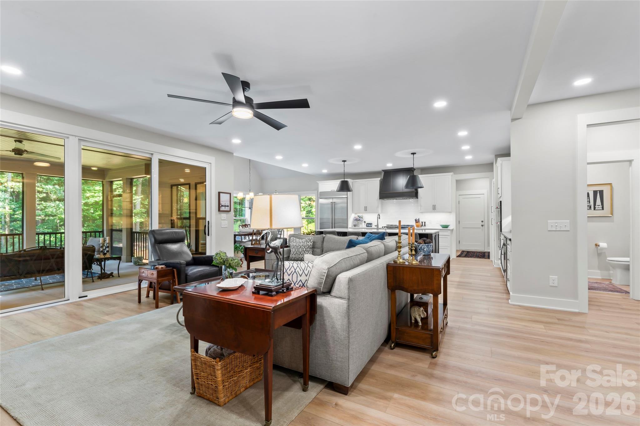 2866 Backwoods Trail Denver, NC 28037 - Photo 11 of 44 a living room with furniture kitchen area and a large window
