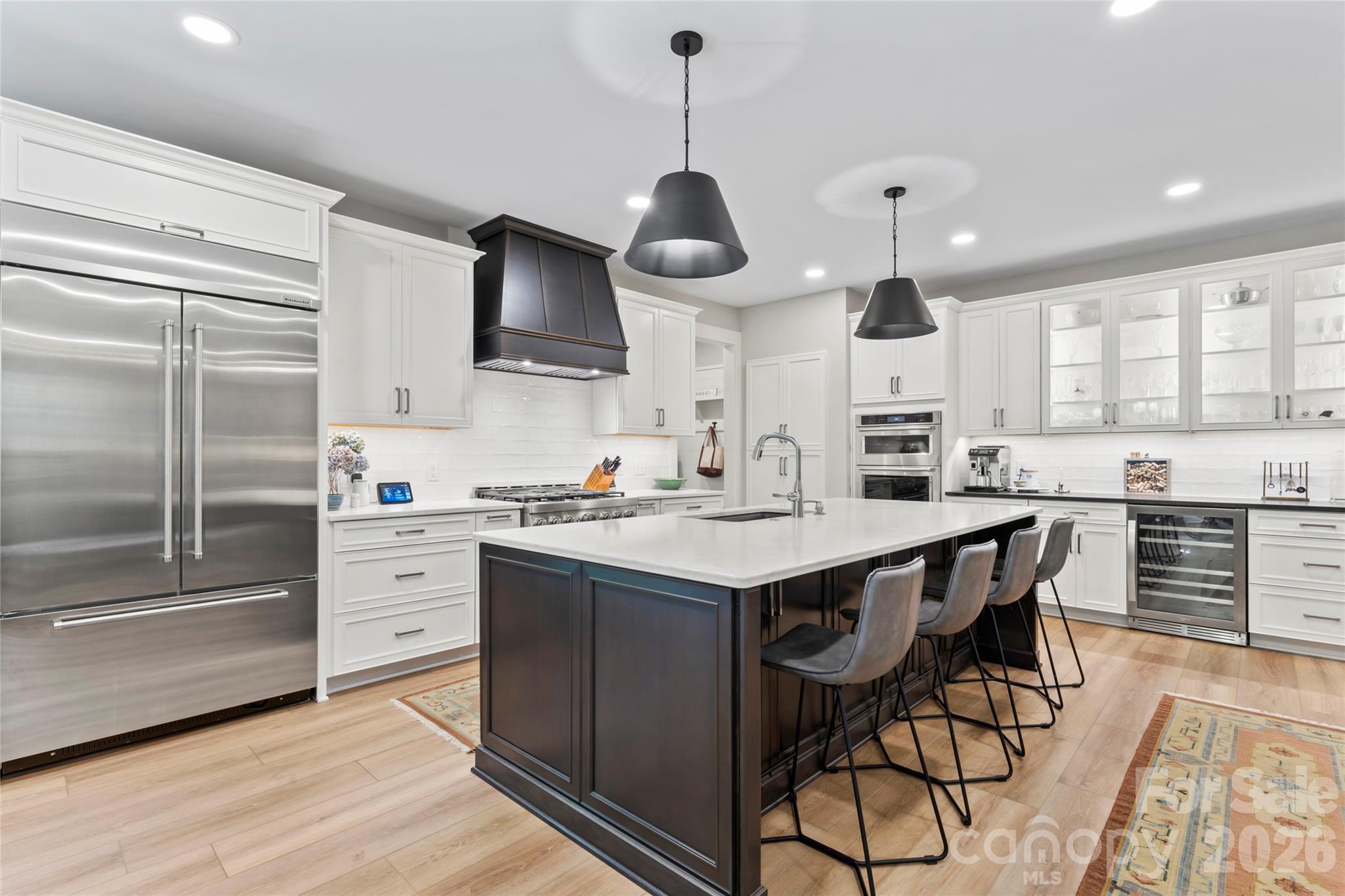 2866 Backwoods Trail Denver, NC 28037 - Photo 12 of 44 a kitchen with stainless steel appliances a stove a sink island and a refrigerator