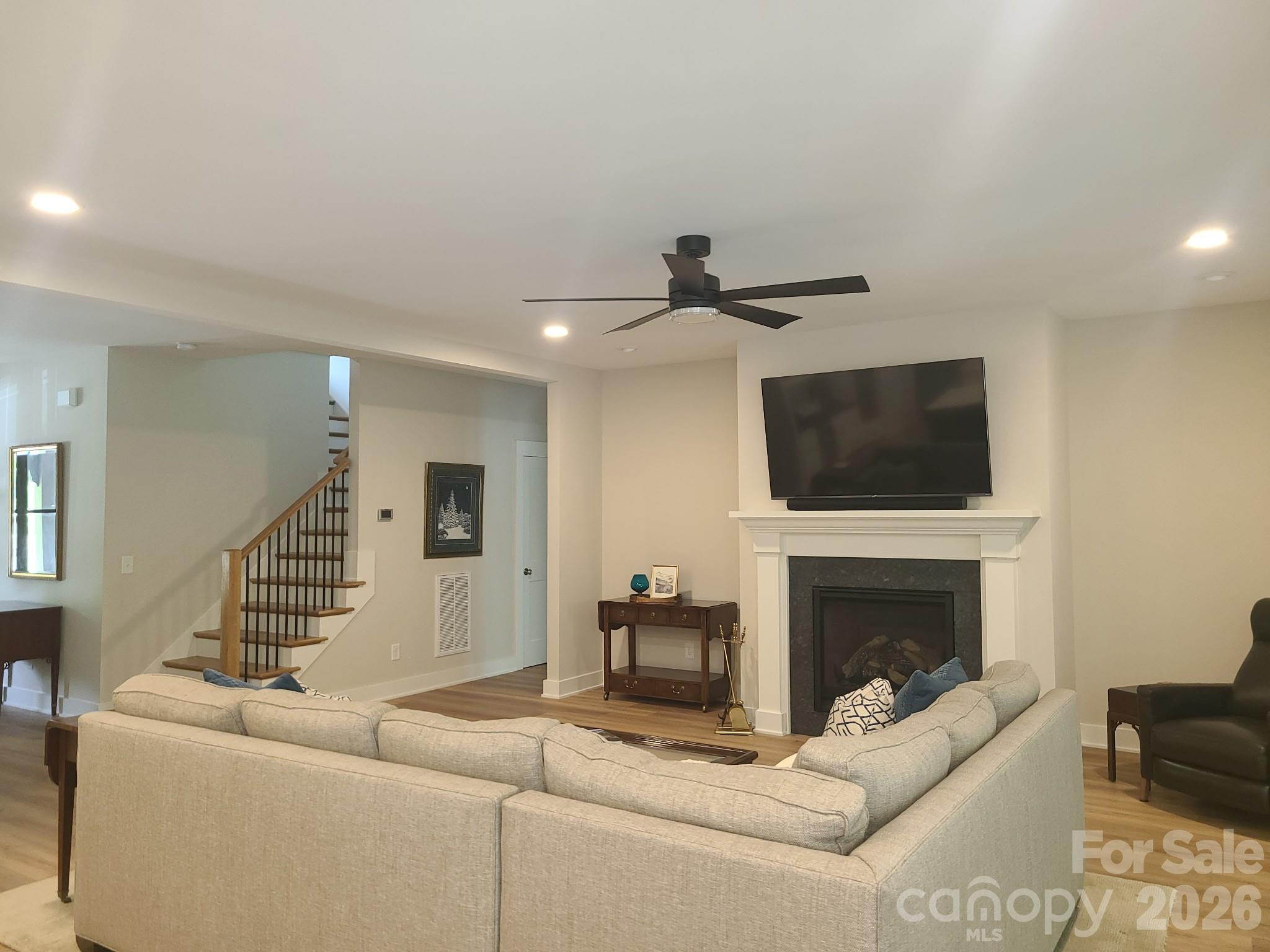 2866 Backwoods Trail Denver, NC 28037 - Photo 12 of 43 a living room with furniture a flat screen tv and a fireplace