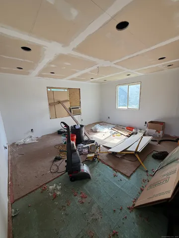 a living room with furniture a ceiling fan and a window