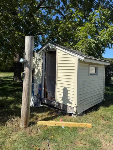 a backyard of a house with table and chairs