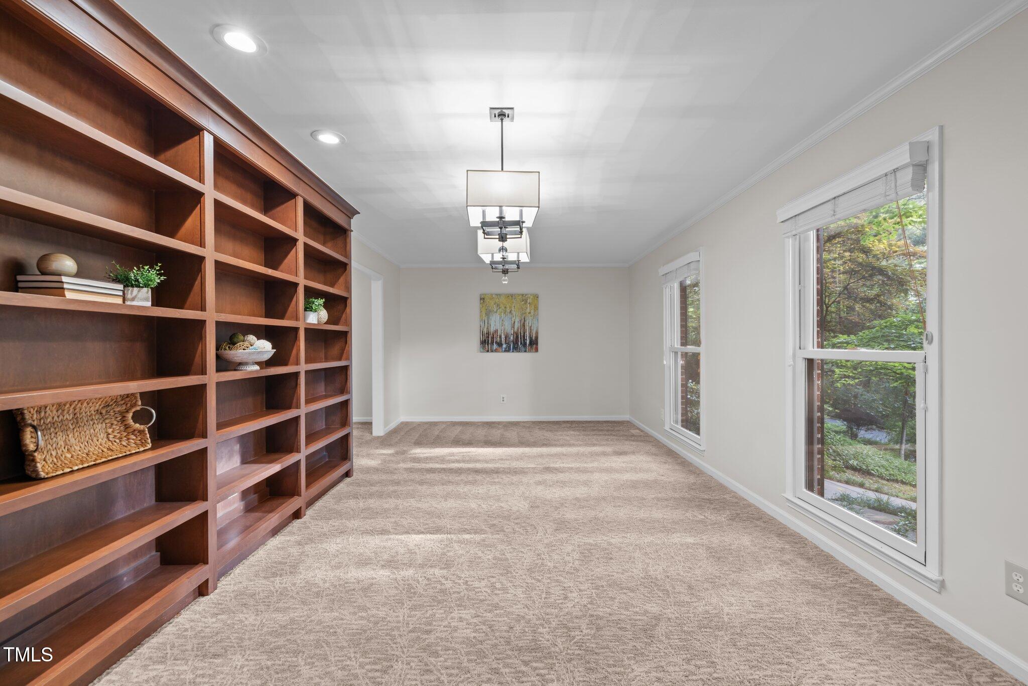 6925 Valley Lake Drive Raleigh, NC 27612 - Photo 16 of 50 a view of an empty room with wooden floor and windows