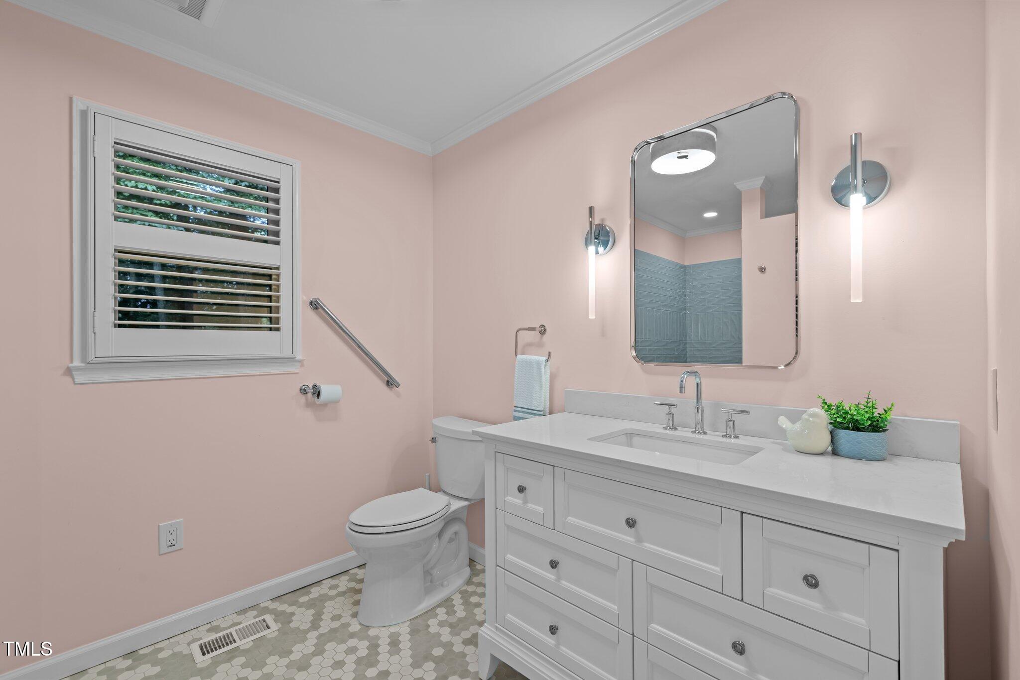 6925 Valley Lake Drive Raleigh, NC 27612 - Photo 20 of 50 a bathroom with a granite countertop sink a toilet and a mirror