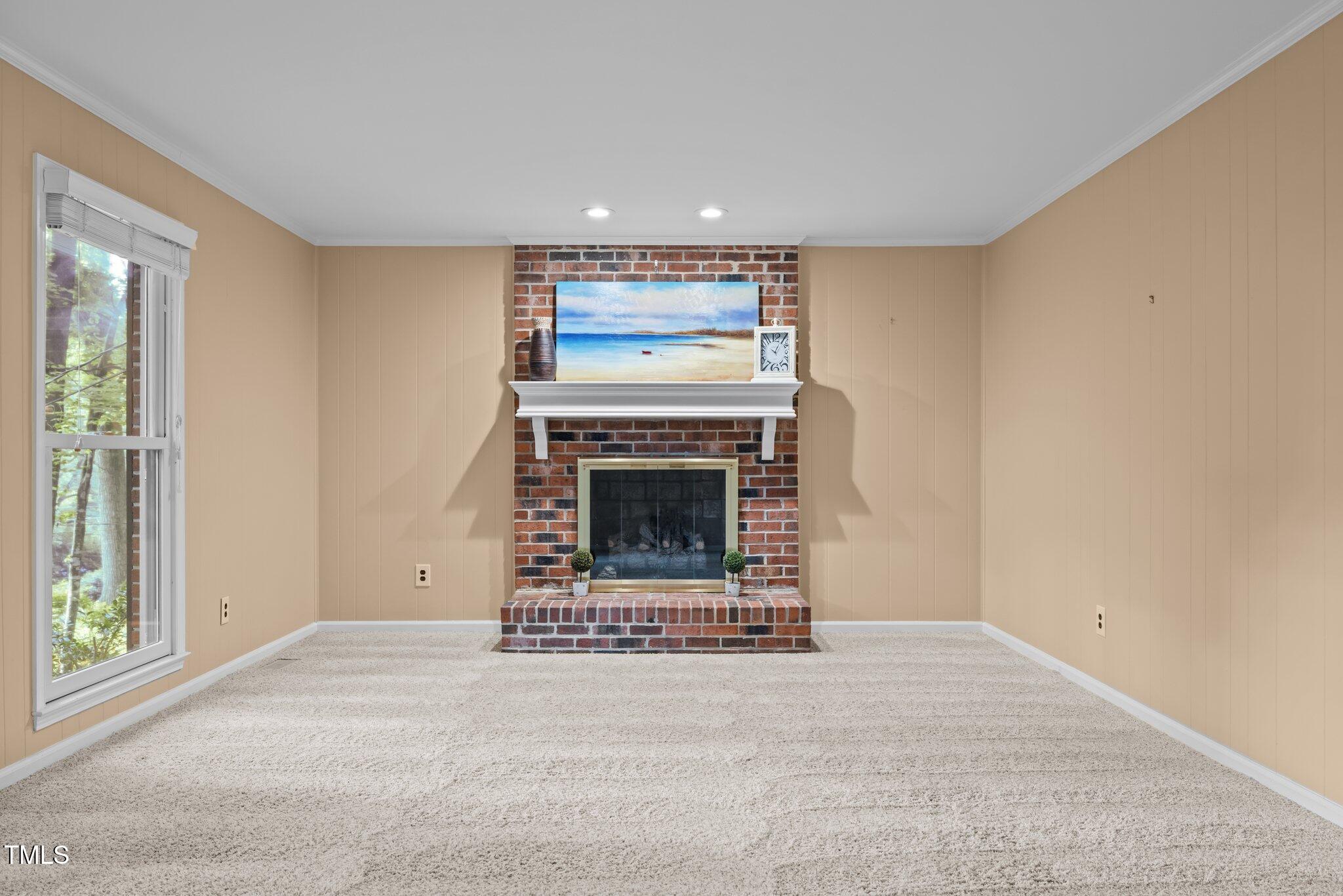 6925 Valley Lake Drive Raleigh, NC 27612 - Photo 7 of 50 a room with a fireplace and a rug
