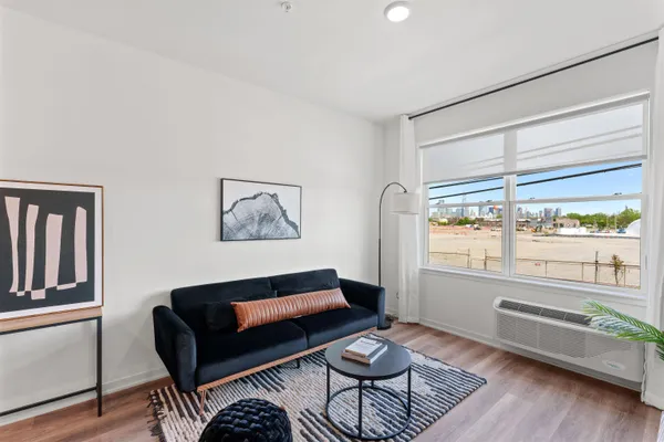 a living room with furniture and a floor to ceiling window