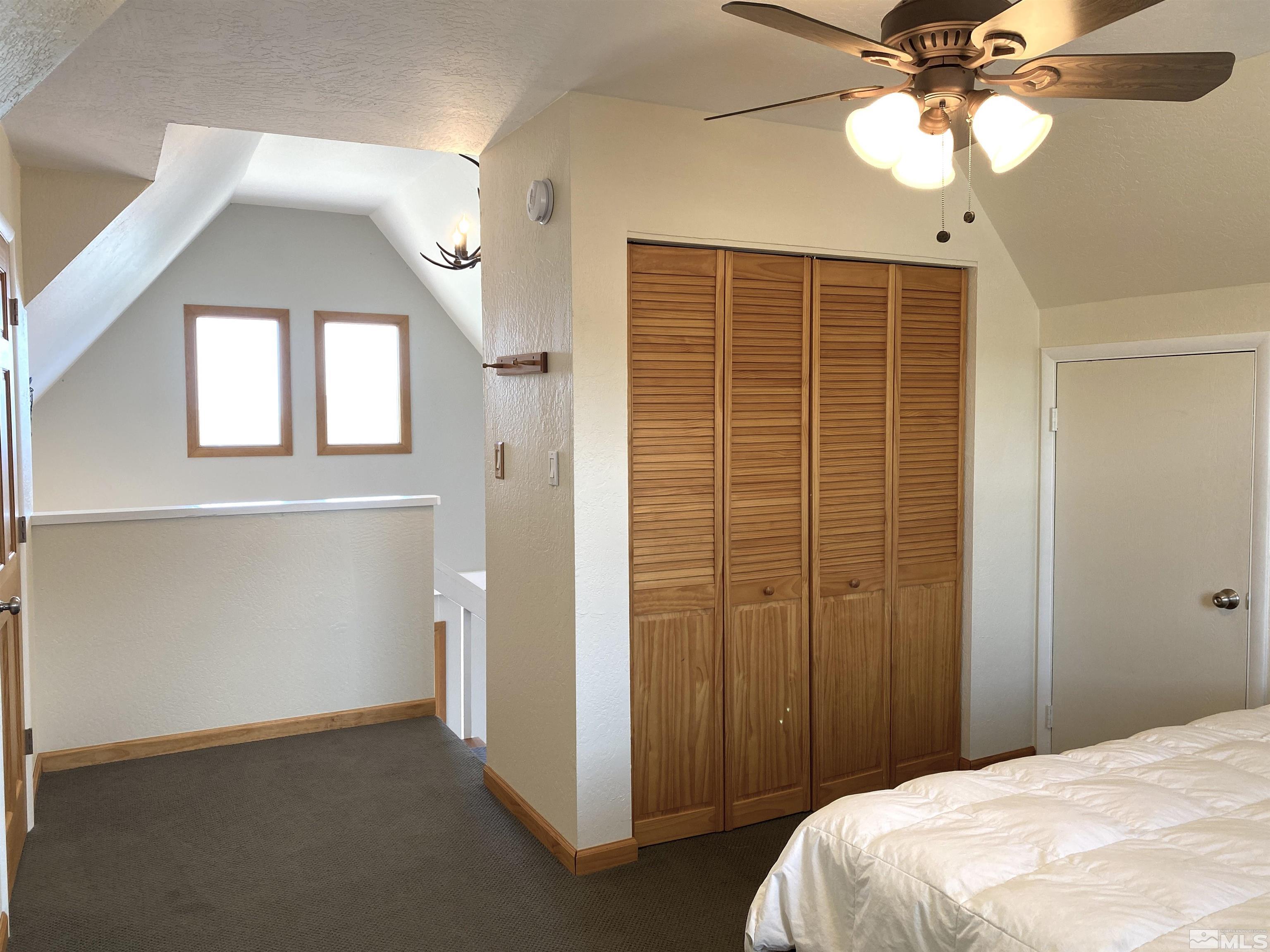 21440 Delta Drive Reno, NV 89521 - Photo 22 of 25 a bedroom with a bed and a chandelier
