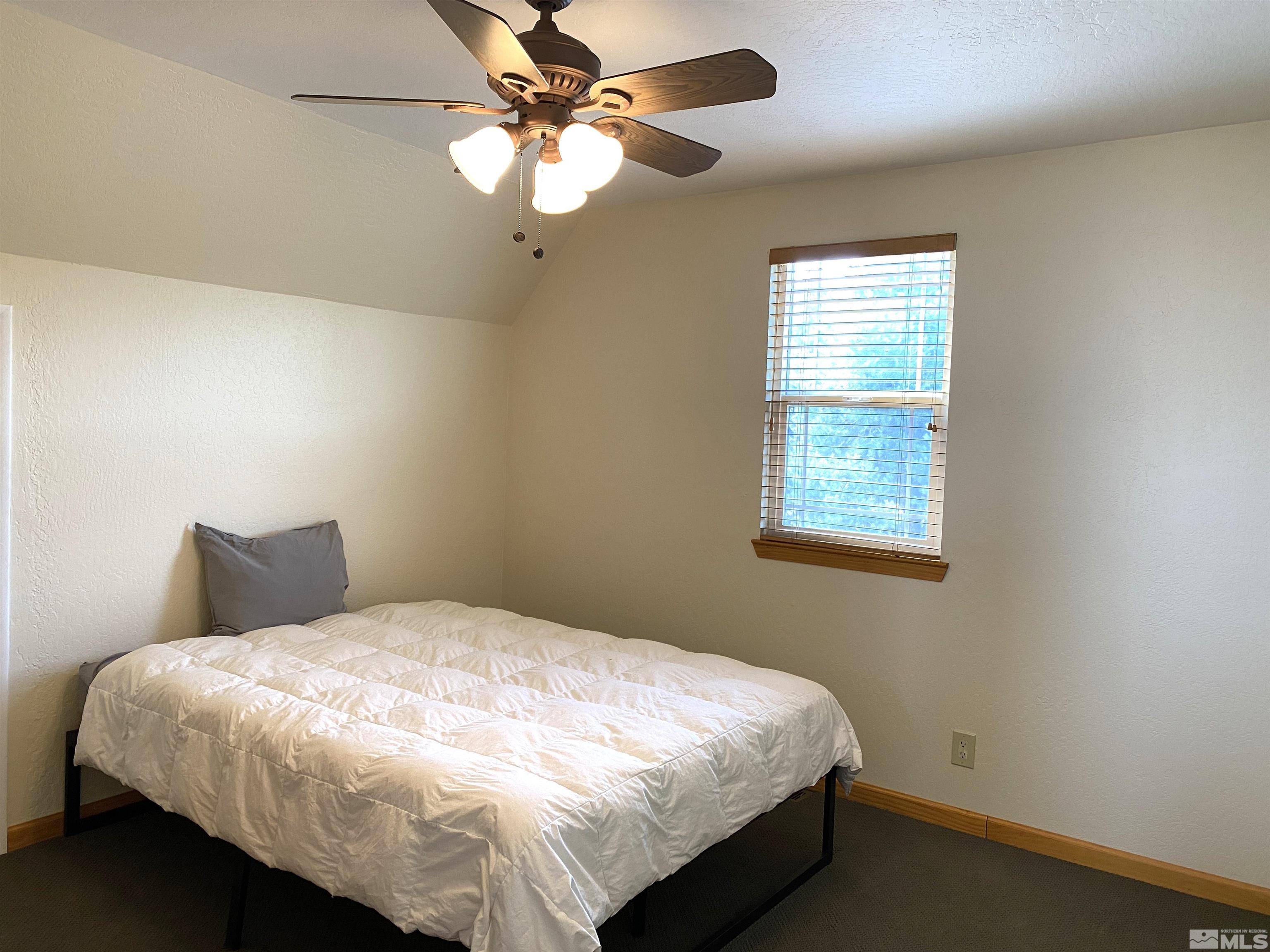 21440 Delta Drive Reno, NV 89521 - Photo 23 of 25 a bedroom with a bed and a window