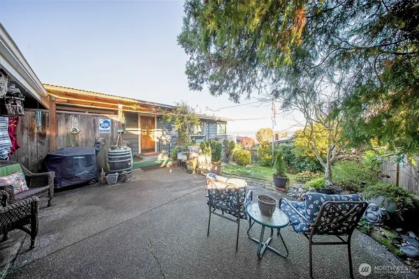 a view of a patio with table and chairs and potted plants