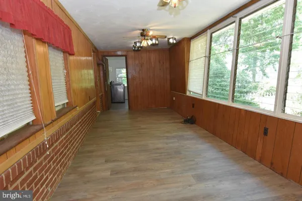 a view of a big room with windows and chandelier