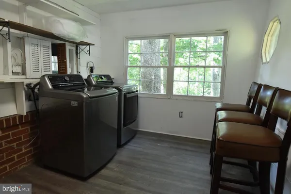 a backyard of a house with barbeque oven table and chairs