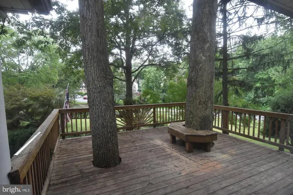 a backyard of a house with wooden floor and outdoor seating