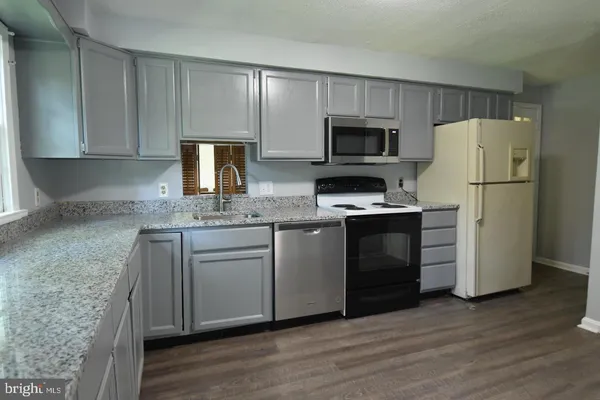 a kitchen with a refrigerator sink and microwave