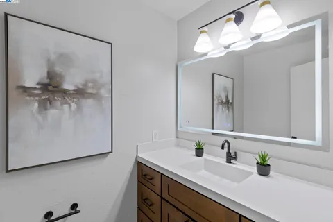 a dining room with furniture and a potted plant