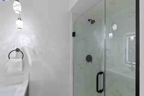 a bedroom with a bed and a night stand