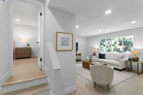 a bedroom with a bed and a lamp on the dresser