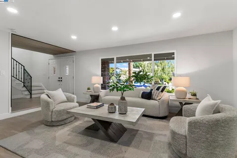 a living room with furniture and a potted plant