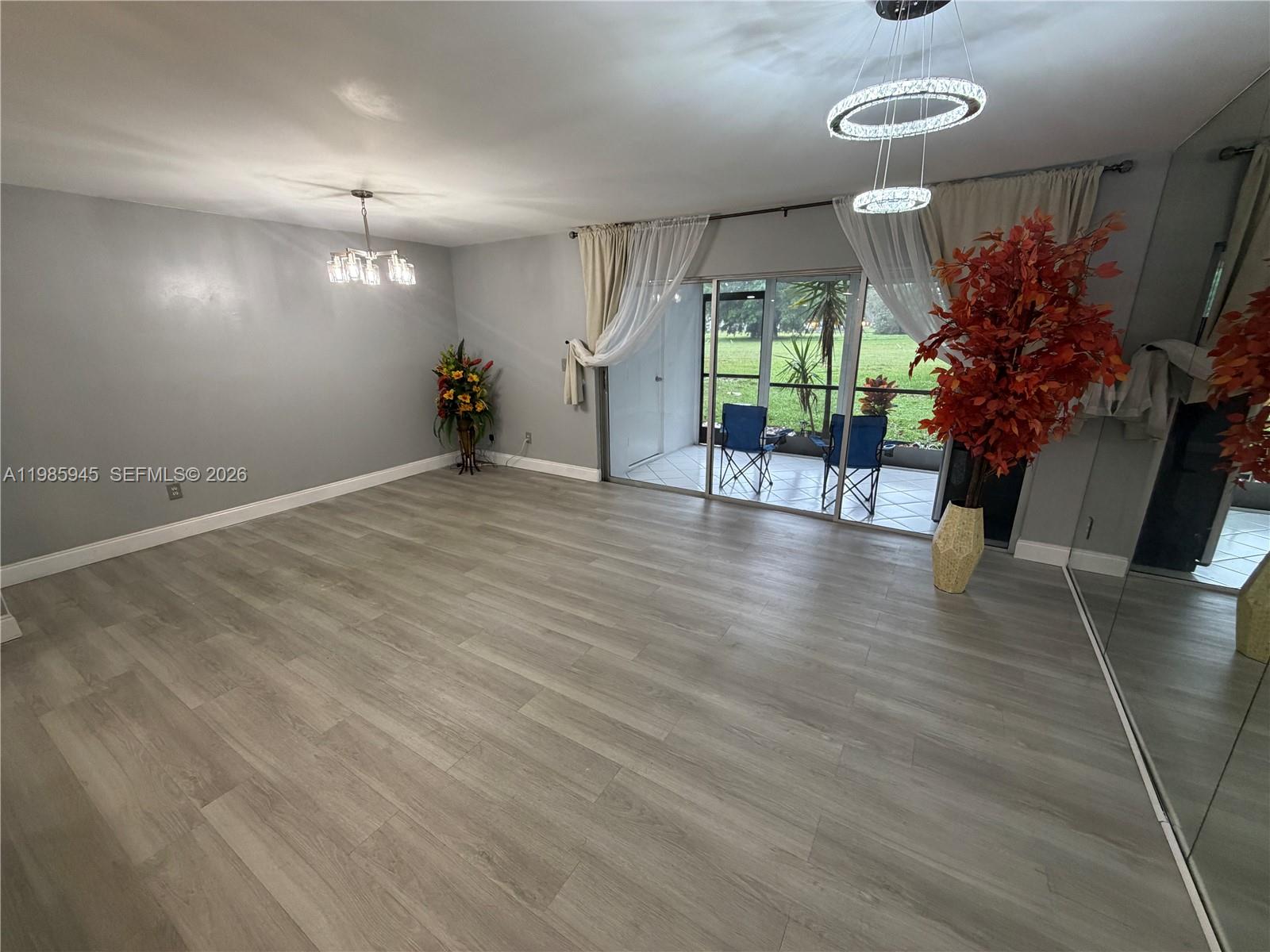 3962 Inverrary Drive, Unit A3 Lauderhill, FL 33319 - Photo 15 of 42 an empty room with wooden floor and windows