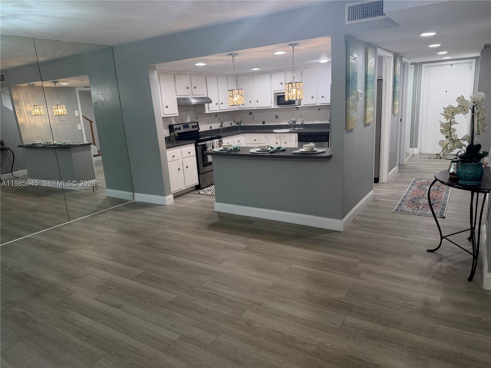 3962 Inverrary Drive, Unit A3 Lauderhill, FL 33319 - Photo 17 of 42 a kitchen with stainless steel appliances granite countertop a stove and a refrigerator