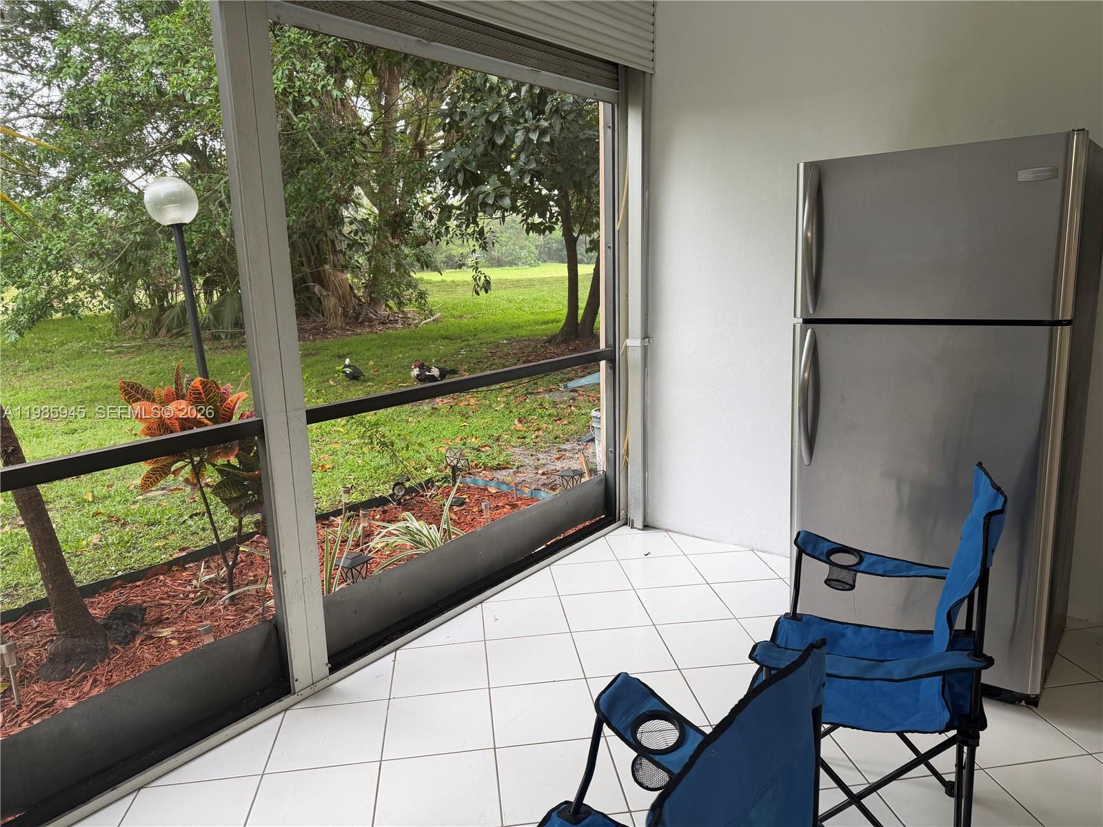 3962 Inverrary Drive, Unit A3 Lauderhill, FL 33319 - Photo 22 of 42 a view of a room with furniture and a yard