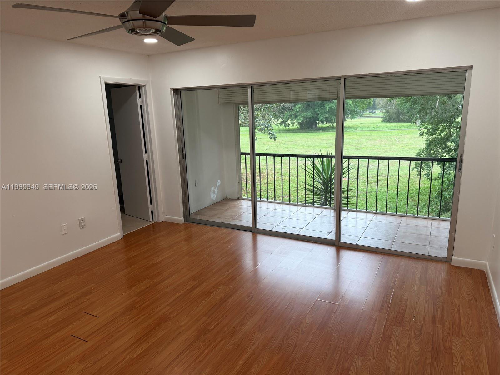 3962 Inverrary Drive, Unit A3 Lauderhill, FL 33319 - Photo 27 of 42 a view of an empty room with wooden floor and a window