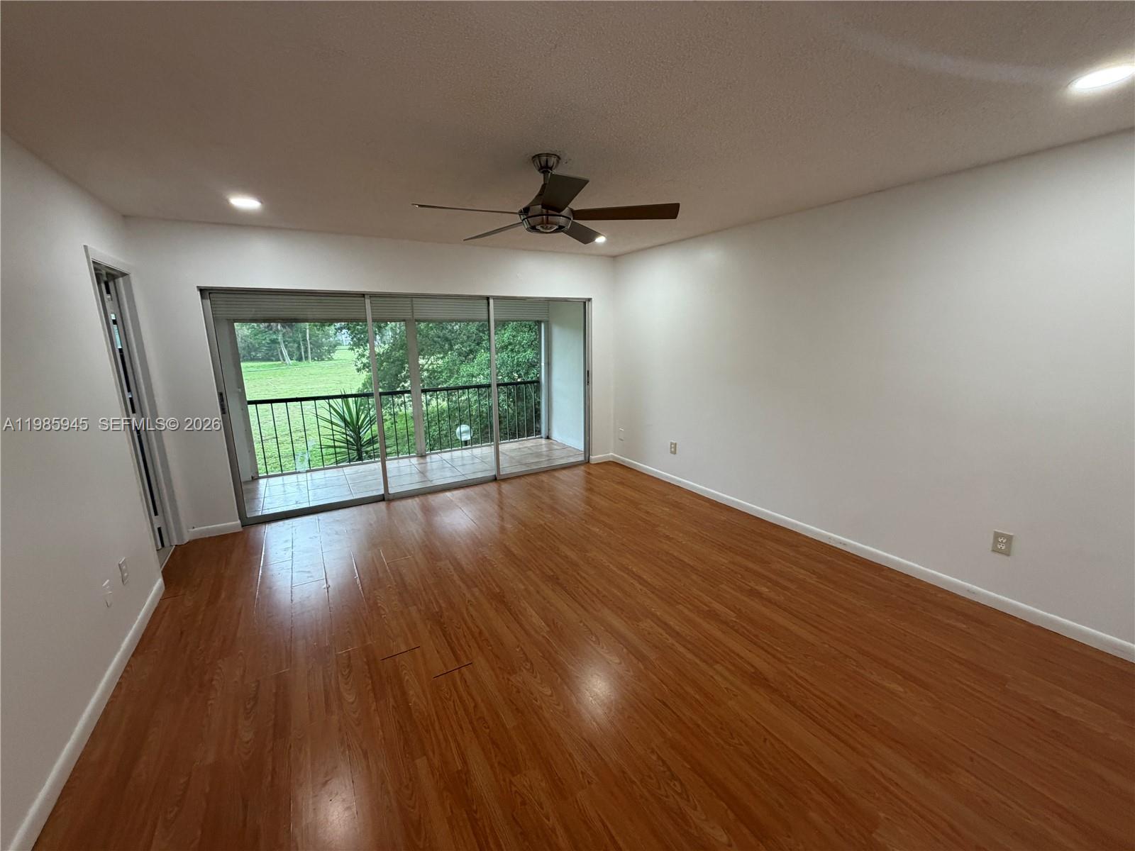 3962 Inverrary Drive, Unit A3 Lauderhill, FL 33319 - Photo 28 of 42 an empty room with wooden floor and windows