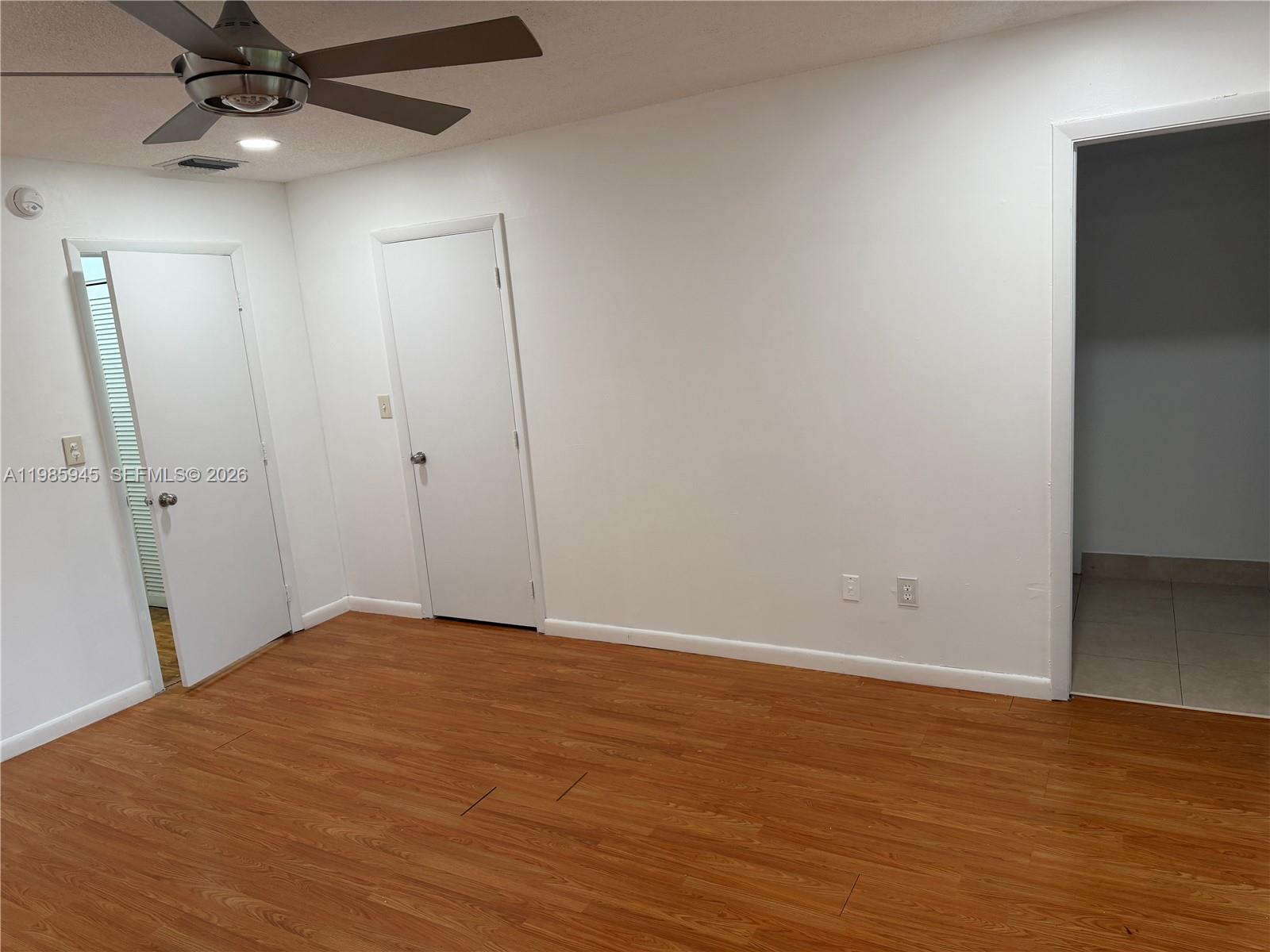 3962 Inverrary Drive, Unit A3 Lauderhill, FL 33319 - Photo 31 of 42 an empty room with wooden floor and fan