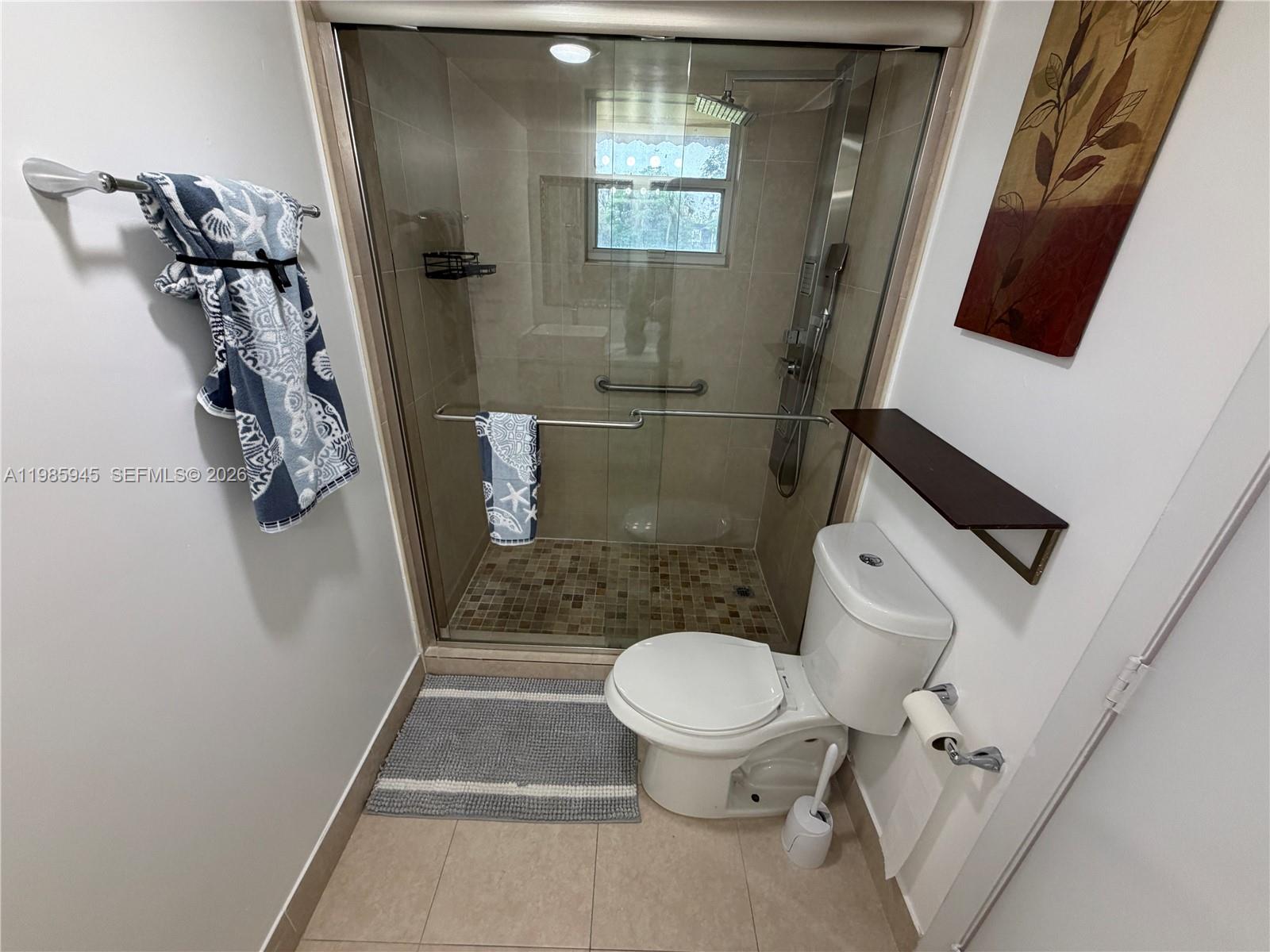 3962 Inverrary Drive, Unit A3 Lauderhill, FL 33319 - Photo 35 of 42 a bathroom with a toilet and a shower