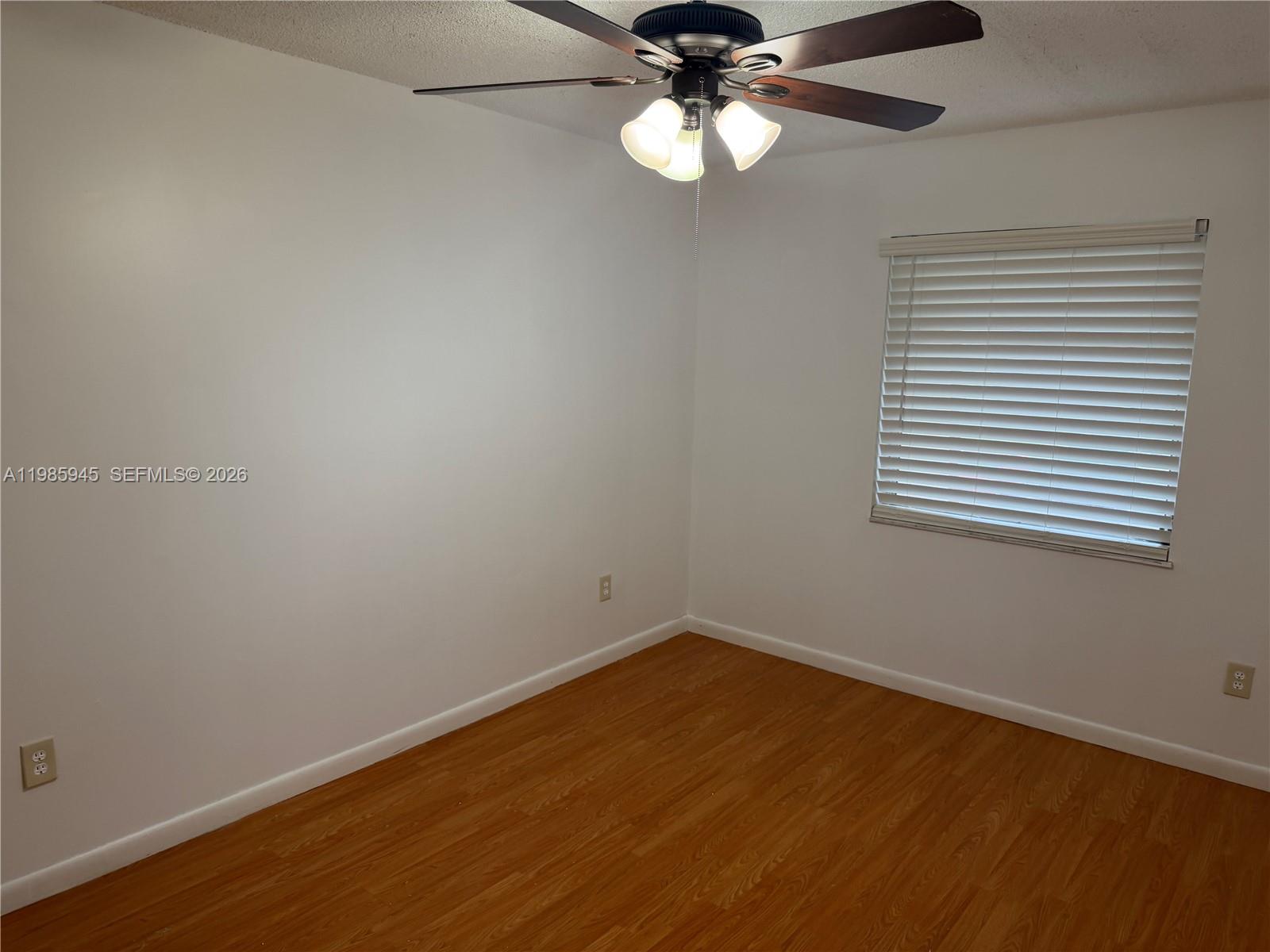 3962 Inverrary Drive, Unit A3 Lauderhill, FL 33319 - Photo 37 of 42 an empty room with a window and ceiling fan